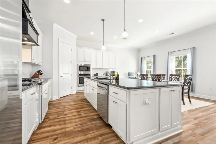 A pristine culinary space features an inviting kitchen island and recessed lighting throughout.