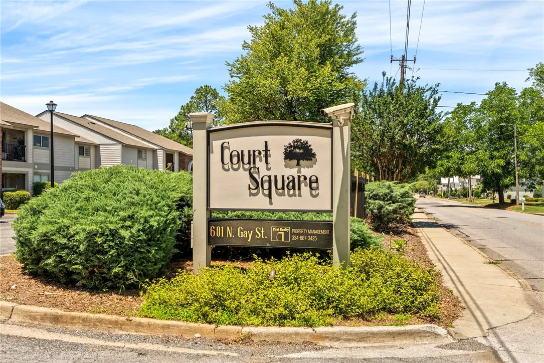 A welcoming sign with lush landscaping beckons residents and visitors to Court Square.