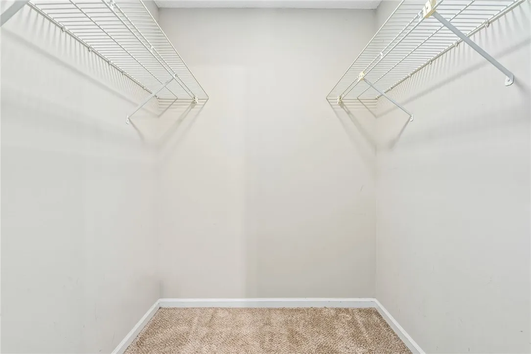 Ample storage solutions await in this naturally illuminated closet, featuring practical wire shelving.