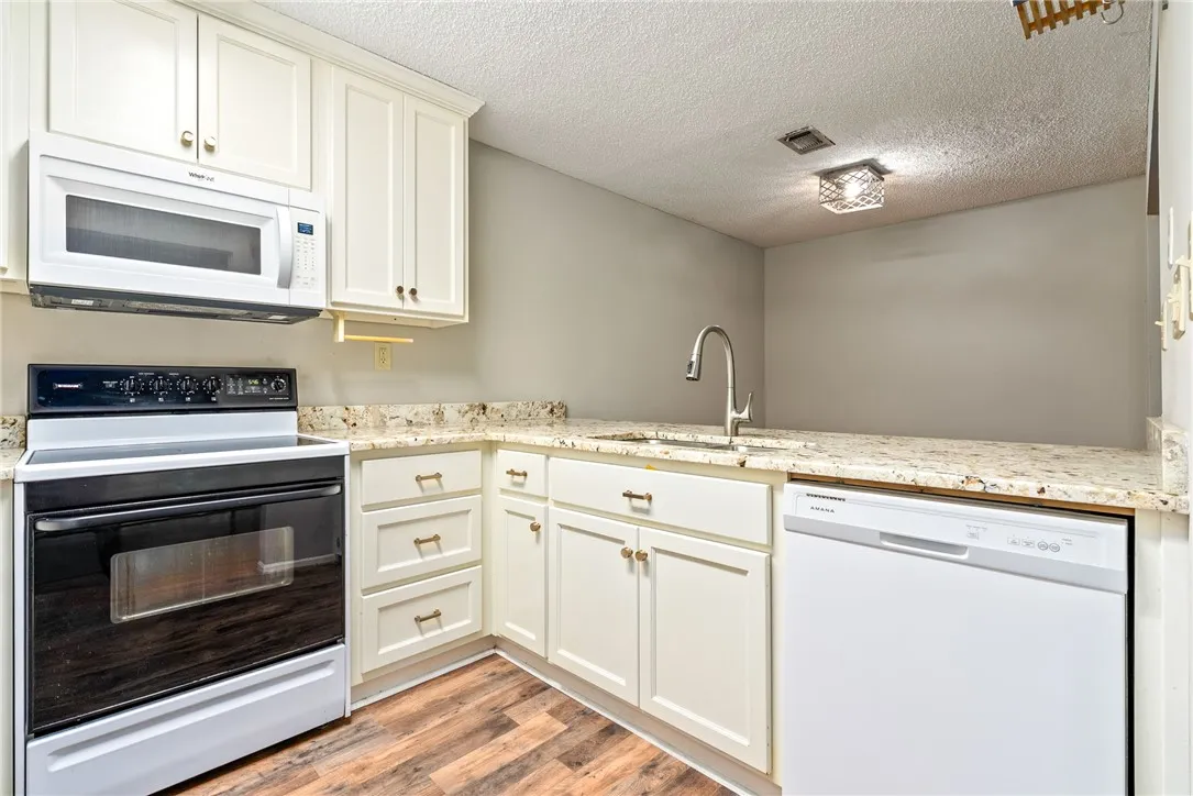 Granite counters and light cabinetry highlight this functional culinary space.
