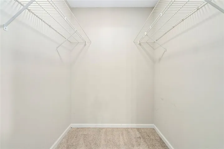 Functional wire shelving provides ample storage solutions in this well-appointed closet.