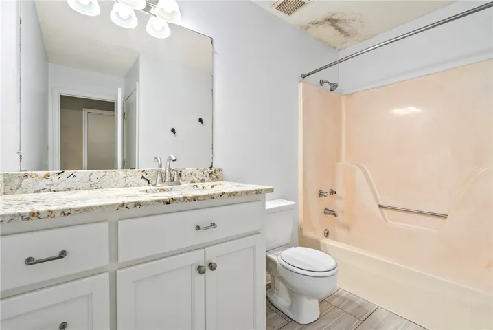 A well-lit bathroom with a spacious vanity, providing both functionality and a crisp aesthetic.