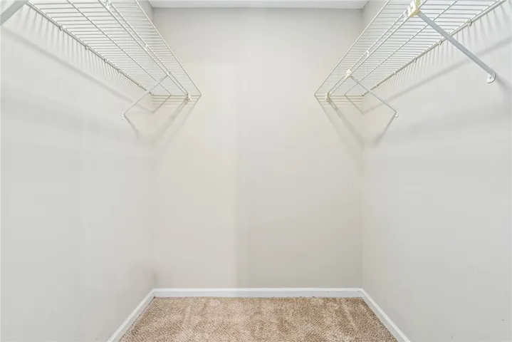 Ample storage solutions await in this naturally illuminated closet, featuring practical wire shelving.
