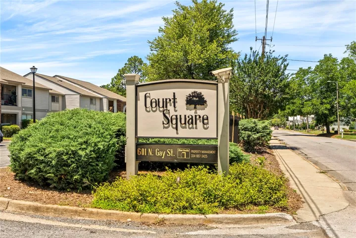 A welcoming sign with lush landscaping beckons residents and visitors to Court Square.