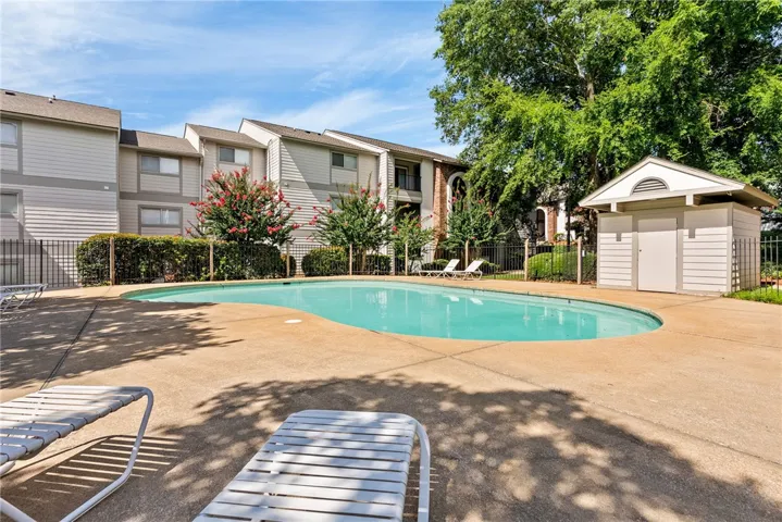 An inviting pool area, featuring an in-ground swimming pool, ready for leisure.