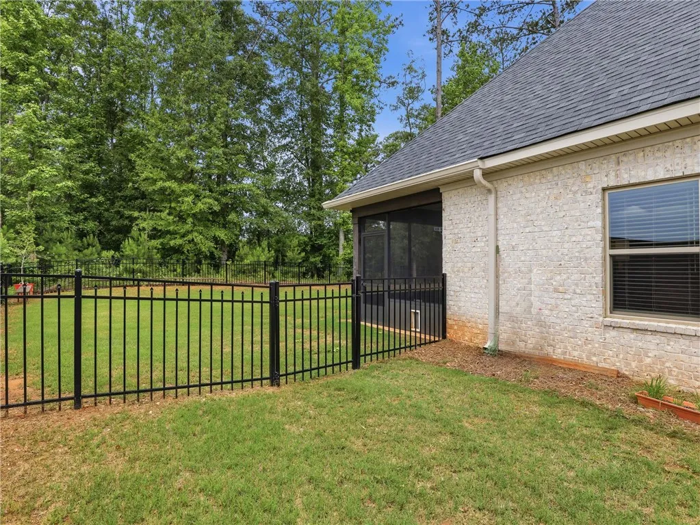 A private, fenced backyard offers tranquil outdoor living, complementing the home's screened porch.