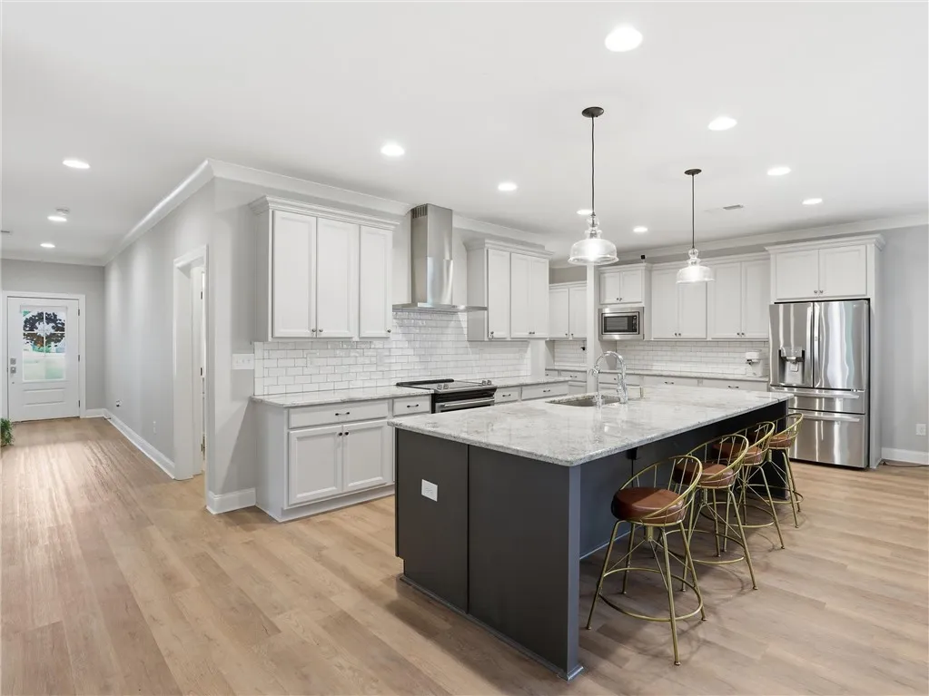 An inviting kitchen with a central island and sleek, modern appliances, perfect for culinary endeavors.