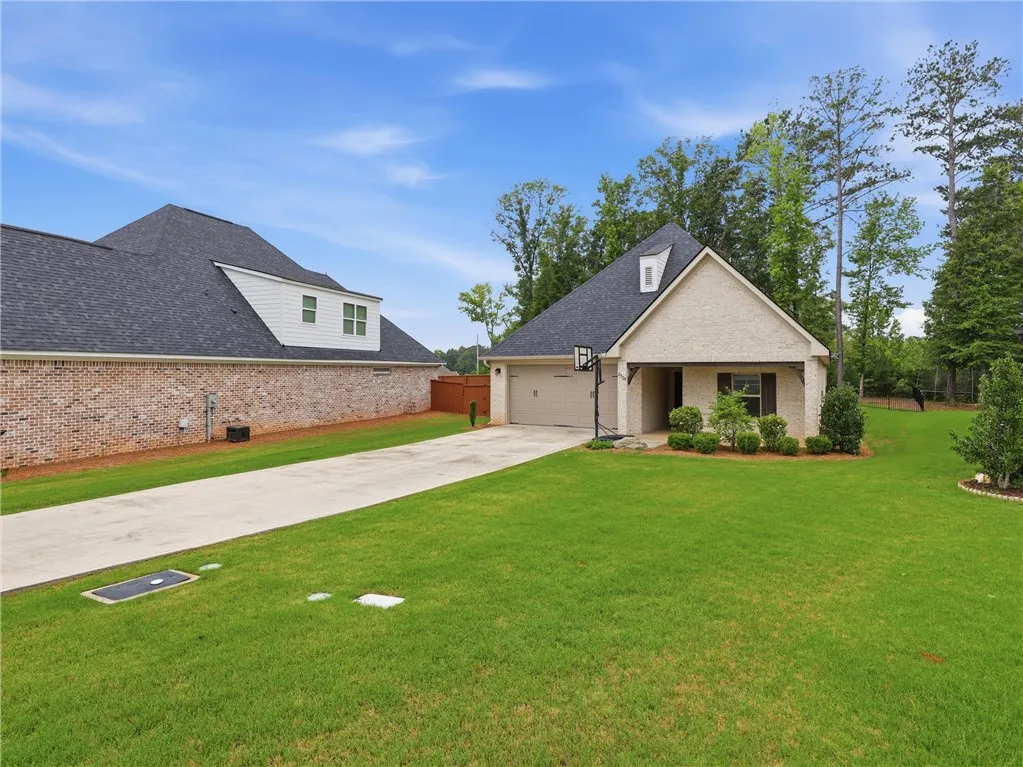 An inviting front elevation showcasing a well-maintained lawn and convenient attached garage.