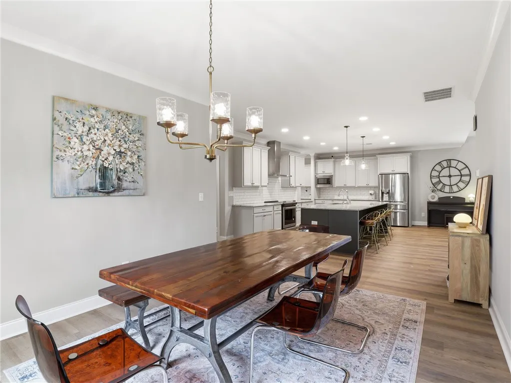 An open concept design seamlessly connects the dining area to a well-appointed kitchen.