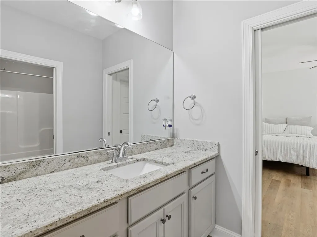 Granite counters and spacious vanity with ample storage for a clutter-free environment.