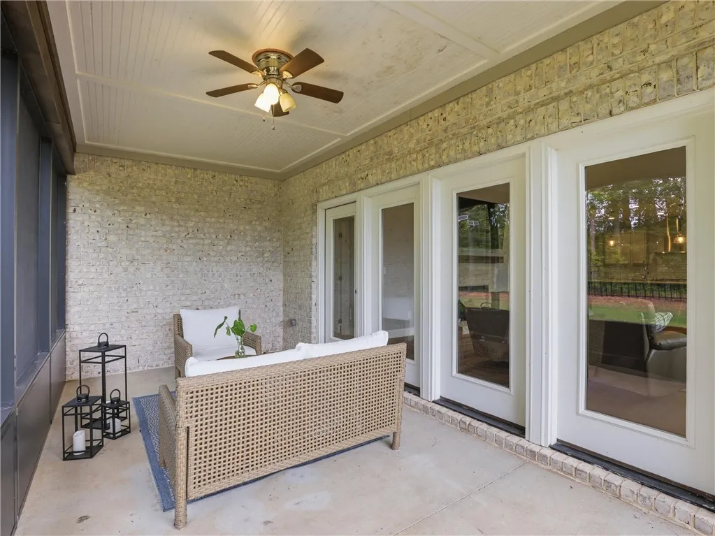 An inviting screened-in porch offers a peaceful retreat with multiple French doors for seamless indoor-outdoor living.