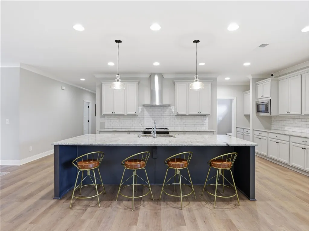 Culinary aspirations come alive in this kitchen, boasting an expansive island with ample seating.