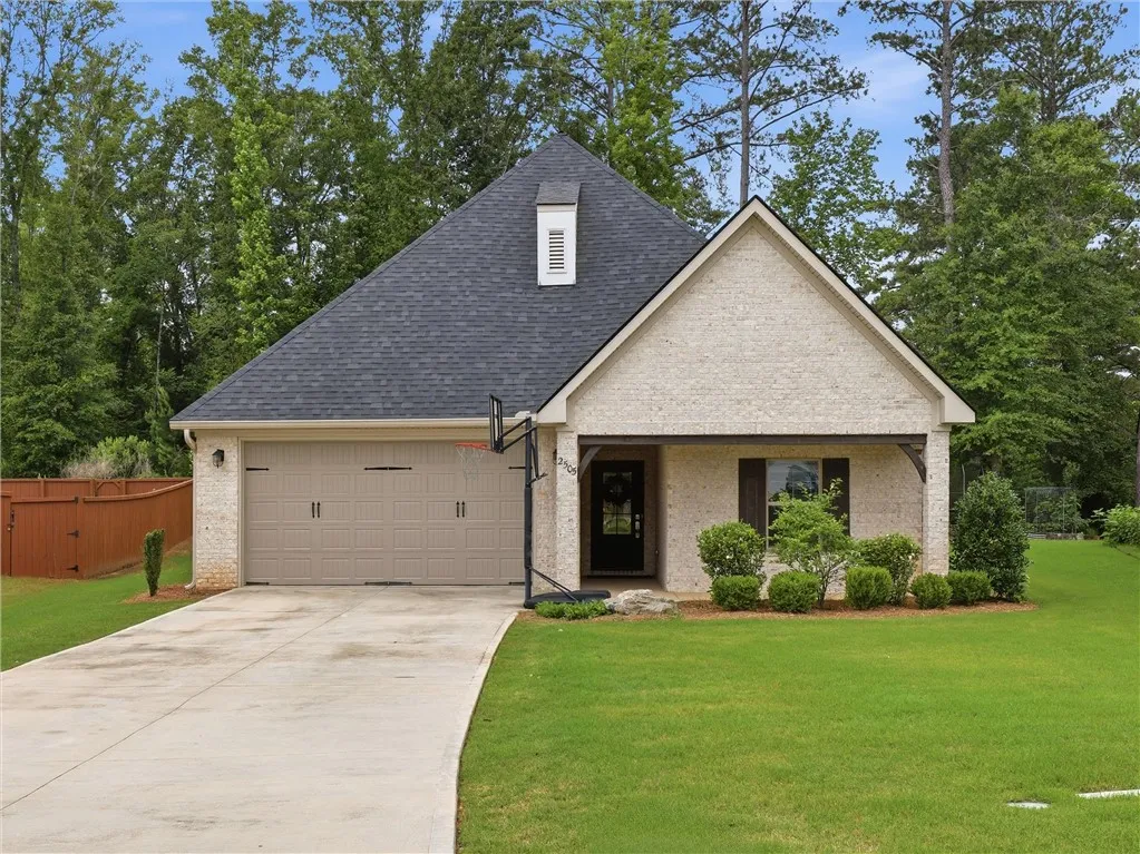 A well-maintained lawn welcomes you to this inviting brick home with an attached garage.