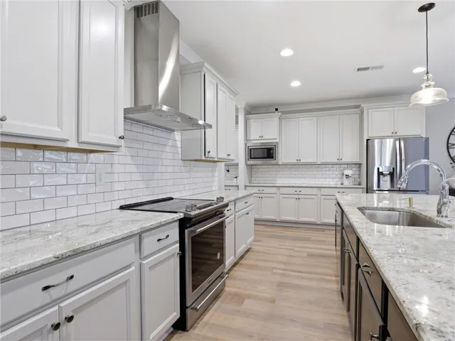 Culinary delights await in this bright kitchen, complete with ample counter space and modern appliances.