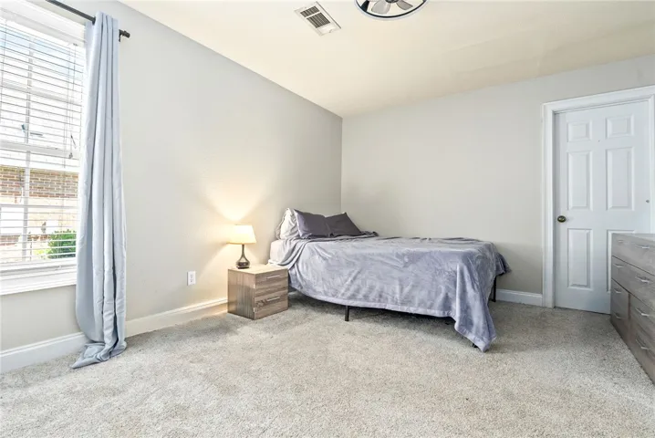 A restful bedroom with soft carpeting awaits, promising peaceful nights.
