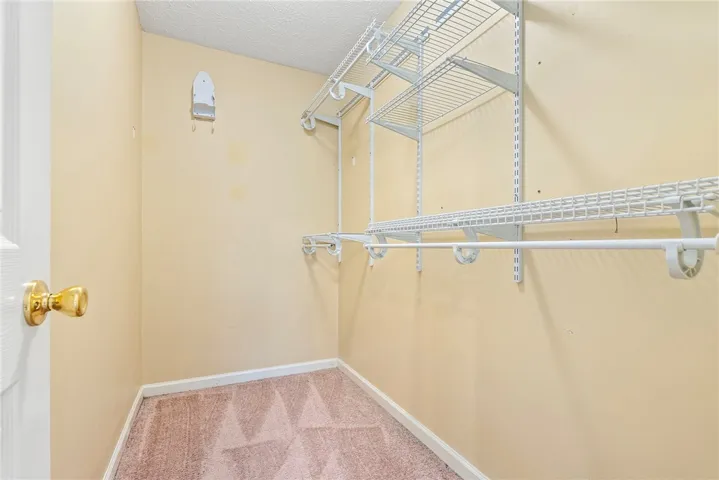 Well-appointed closet space offers ample wire shelving and hanging rods for effortless organization.