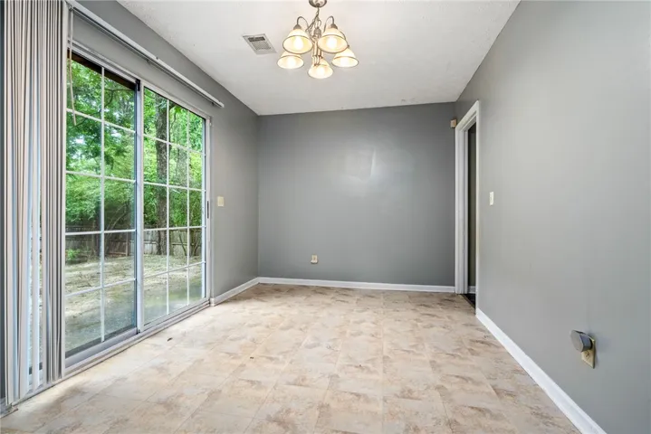 Bright dining area with sliding glass doors opening to the outdoors.