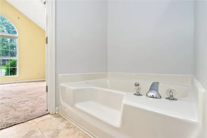 Indulge in a relaxing soak in this pristine bathtub, offering a tranquil escape.