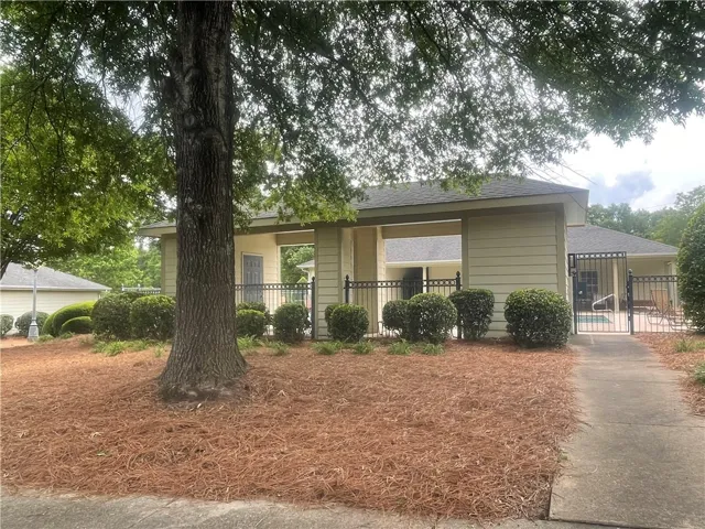 A well-maintained community building offers inviting pool access.