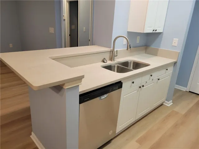A well-appointed kitchen features a double basin sink and stainless steel appliances.