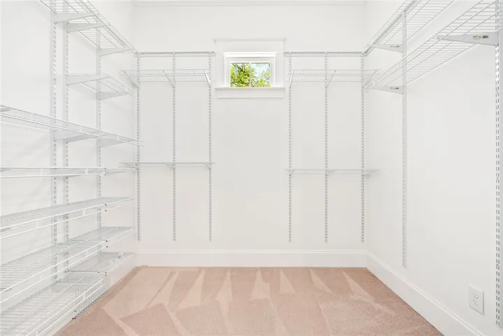 Ample storage solutions define this practical walk-in closet, ready for personalized organization.
