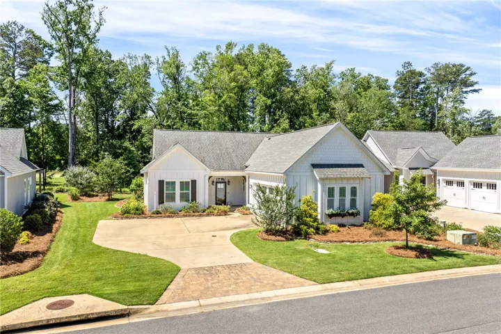 A classic facade with a curved driveway and well-kept green lawns welcomes all who visit.