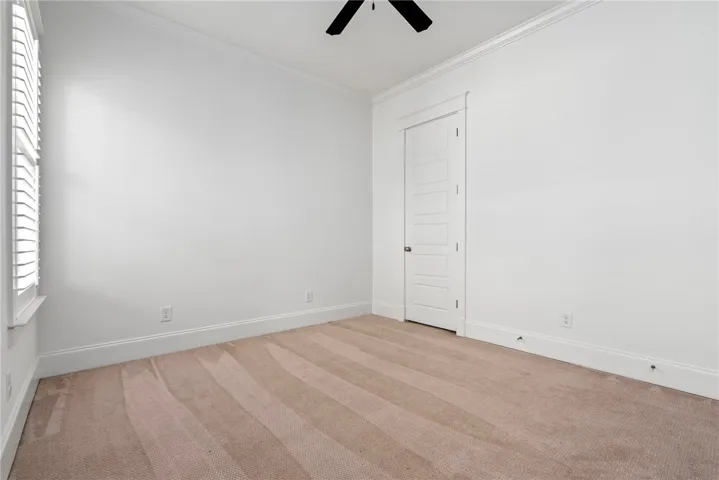 A well-lit bedroom offering a pristine canvas for personalized decor and comfortable living.