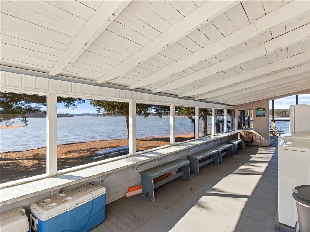 A spacious covered porch offers mesmerizing views of the lake and surrounding natural beauty.