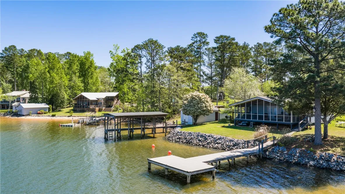 A tranquil lakeside retreat with multiple docks and lush green surroundings.