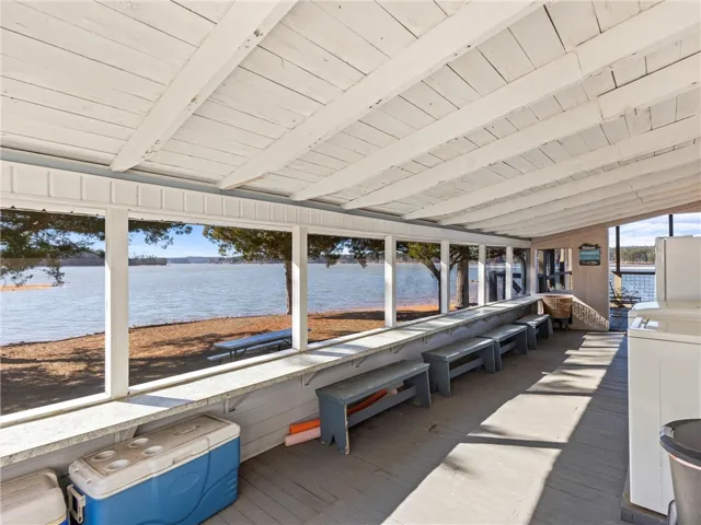 A spacious covered porch offers mesmerizing views of the lake and surrounding natural beauty.