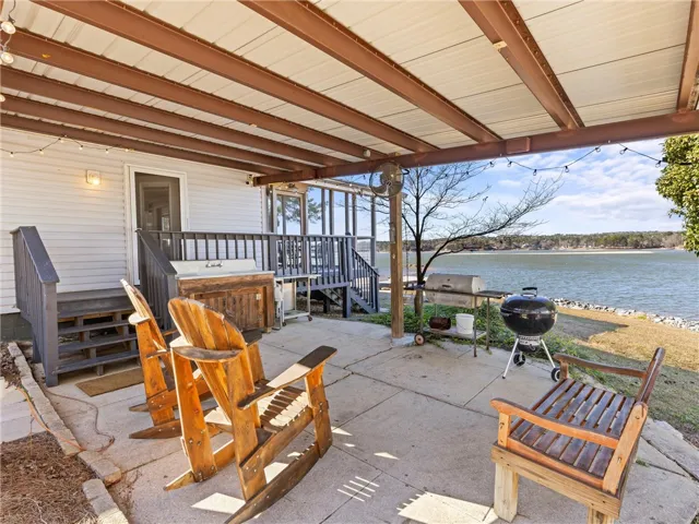 Enjoy lakeside living from this covered patio, perfect for grilling and outdoor relaxation.