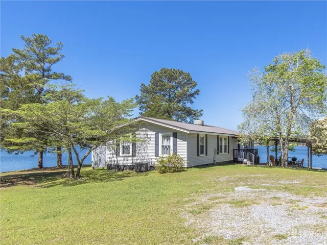 Lakeside home featuring a charming covered patio and picturesque water views.
