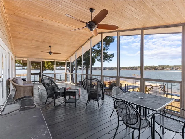 A spacious screened porch offers unparalleled waterfront views and an inviting outdoor living space.
