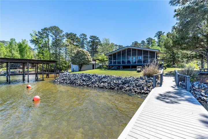 Boasting a private dock and screened-in porch, this lakeside retreat offers serene waterfront living.