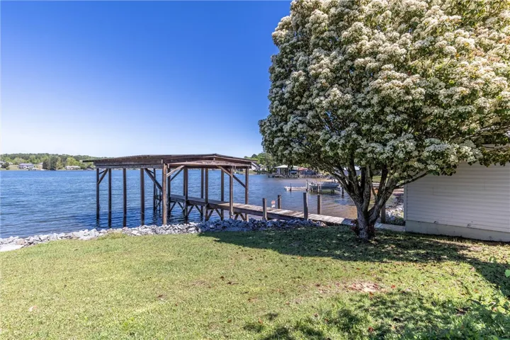 Boathouse and dock offer direct water access from this charming lakeside property.