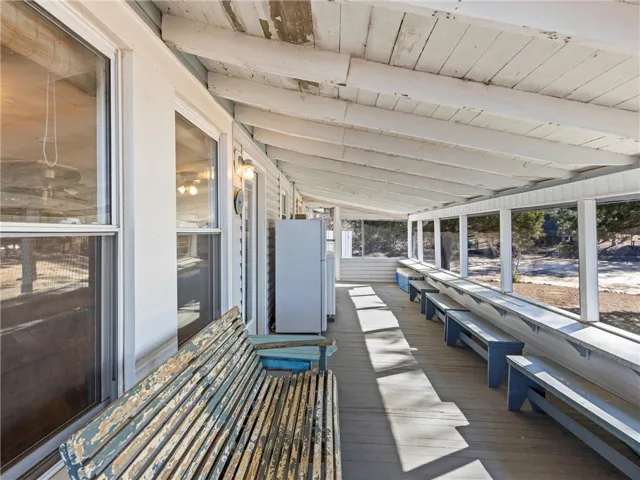 A deep screened porch provides a perfect spot for enjoying the outdoors in comfort.
