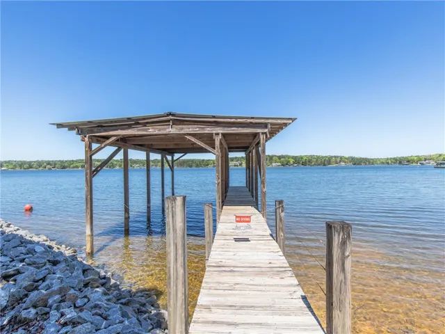 Boathouse with a private dock offers serene waterfront enjoyment and direct lake access.