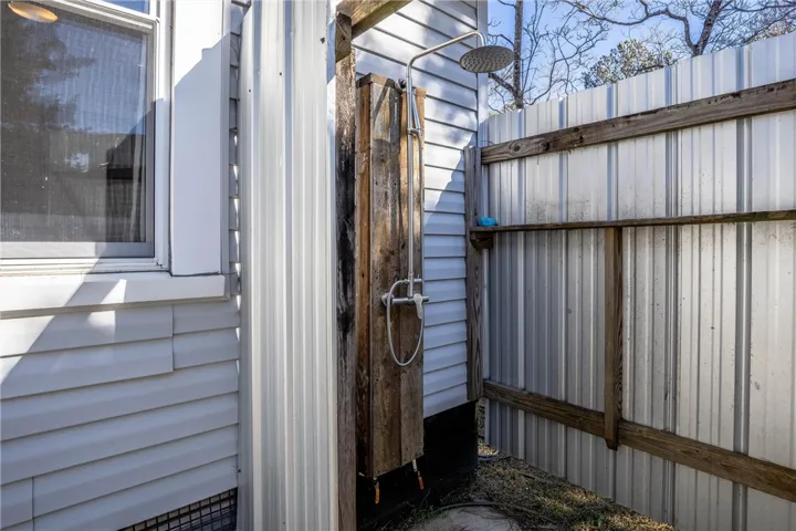 An outdoor shower area provides a refreshing rinse under the open sky.