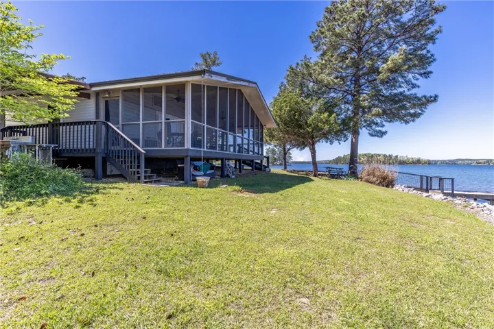 Experience lakeside living from this home with a spacious screened porch and private dock access.