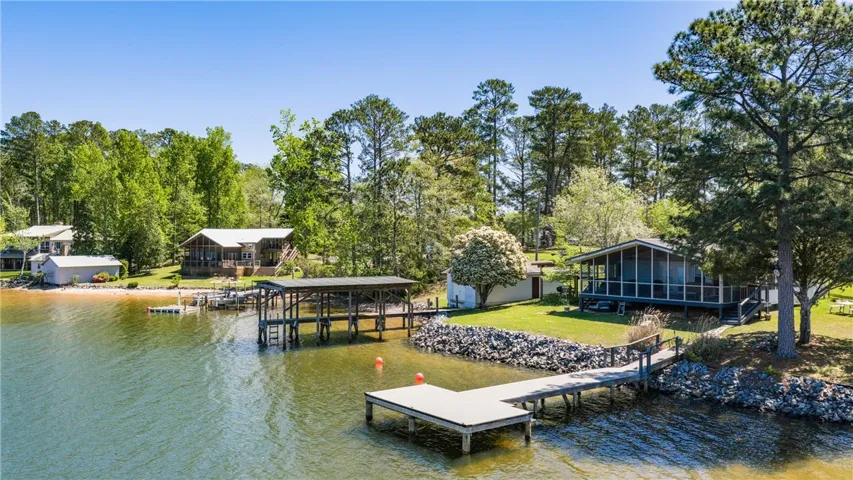 A tranquil lakeside retreat with multiple docks and lush green surroundings.