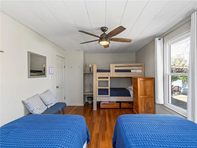 Hardwood floors and a bunk bed provide versatile sleeping options in this well-appointed bedroom.