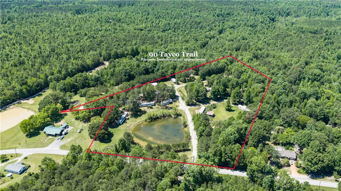  expansive parknestled amidst verdant woodlands with a serene pond.