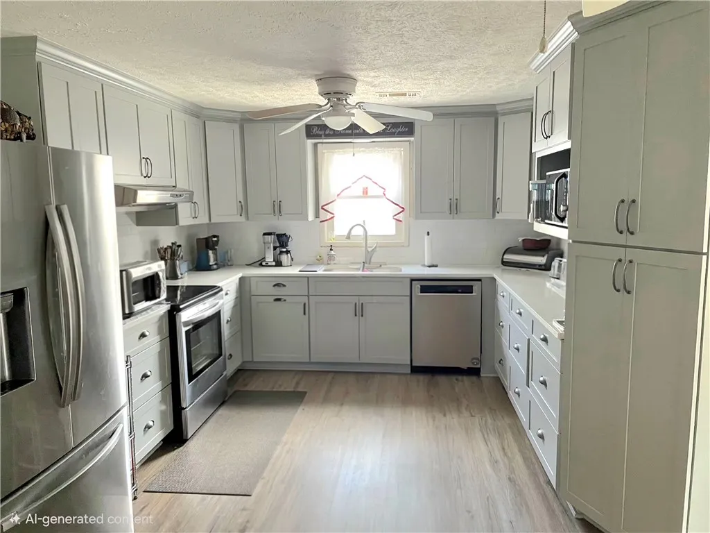 A well-appointed kitchen features stainless steel appliances, ample cabinetry, and practical flooring.