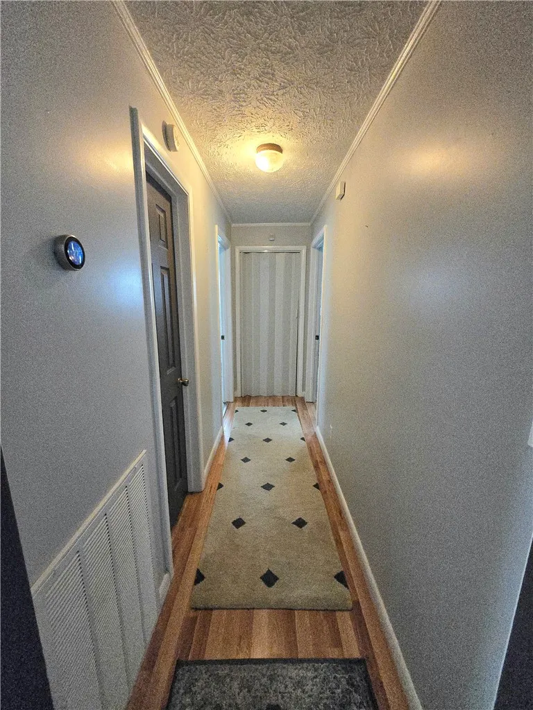 Hardwood flooring extends through this well-lit interior hallway.