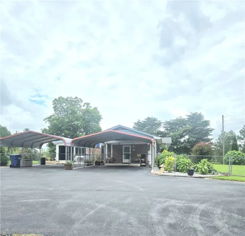 A broad paved driveway leads to dual carports providing ample sheltered parking.