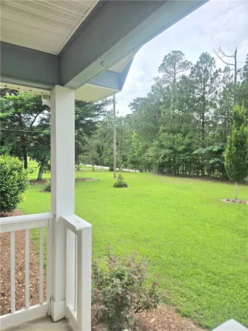 Green grounds extend from the porch.