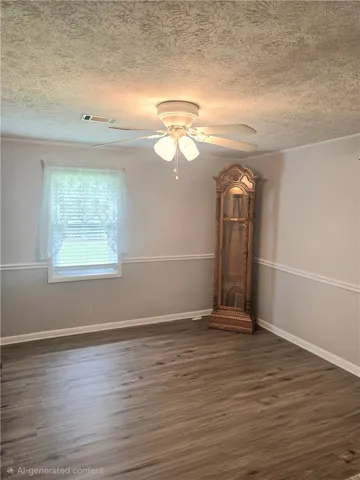 A quiet space featuring resilient vinyl plank flooring and a ceiling fan for comfort.