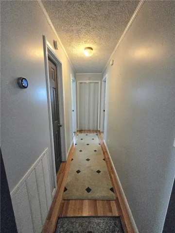 Hardwood flooring extends through this well-lit interior hallway.