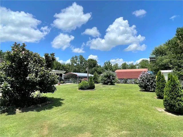 A verdant backyard offers ample space for recreation and relaxation, complemented by mature landscaping.