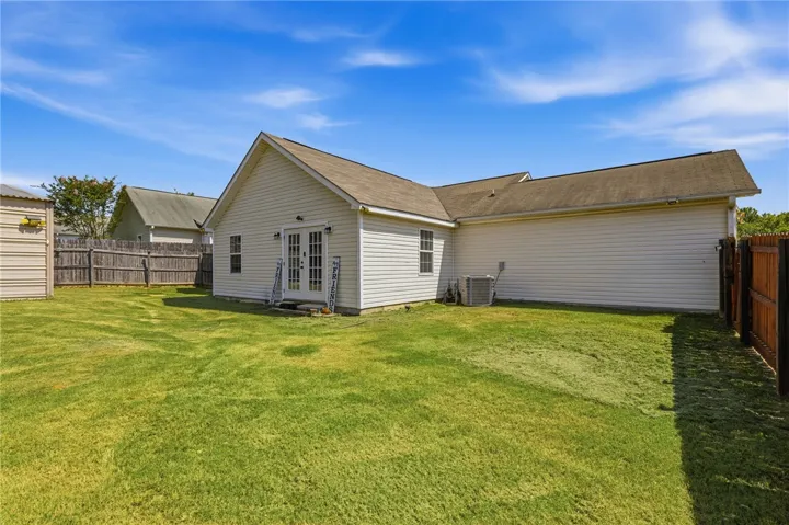 A well-maintained lawn provides a verdant backdrop to this comfortable residence, featuring practical outdoor space.